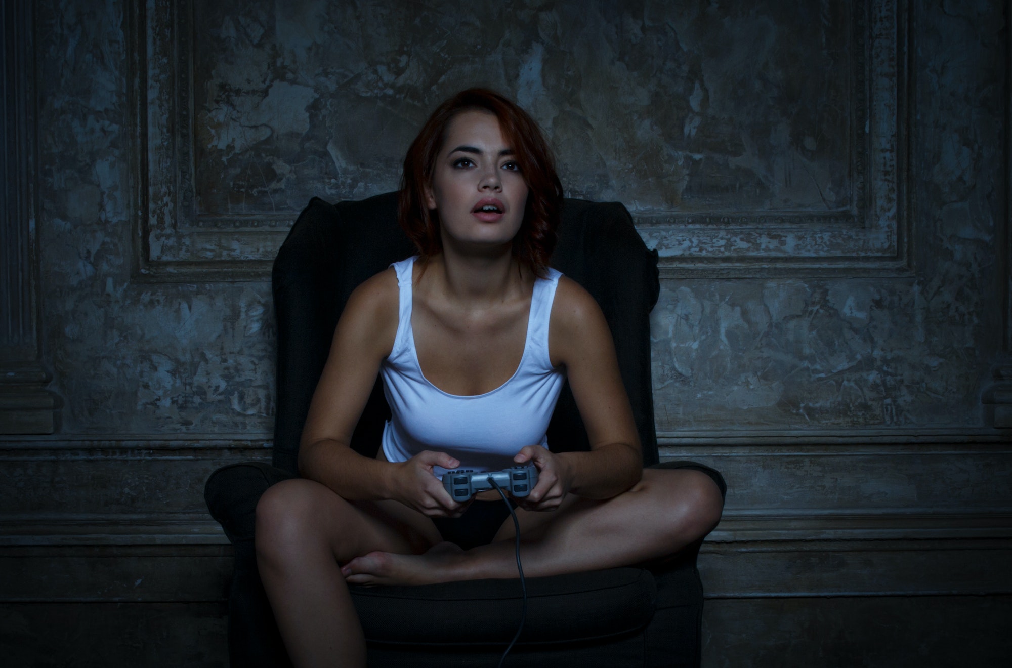 sexy woman with game pad playing video games